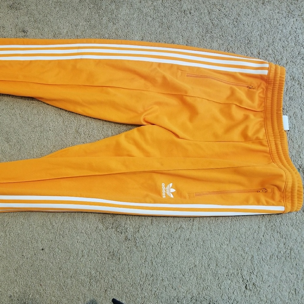 Orange adidas track pants